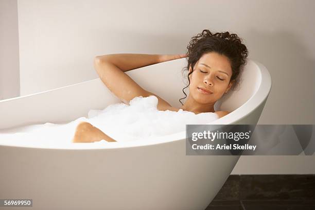 woman sleeping in bubble bath - bubblebath stock pictures, royalty-free photos & images