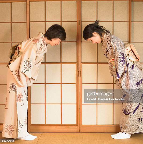 two asian women bowing - buga bildbanksfoton och bilder