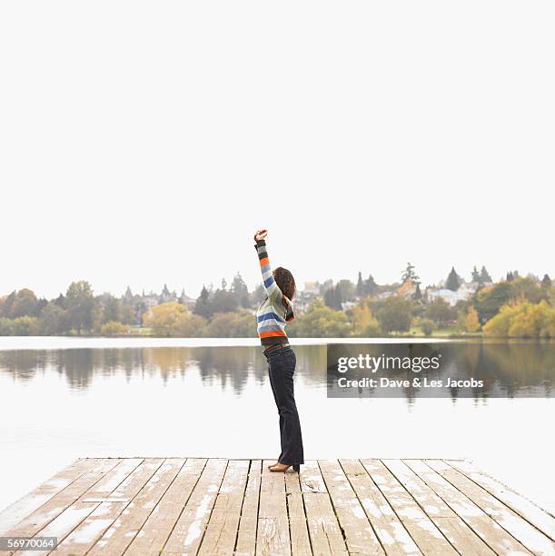 woman stretching on dock - fall in seattle fotografías e imágenes de stock