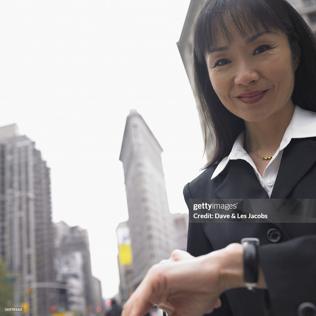 Businesswoman smiling with cityscape behind her