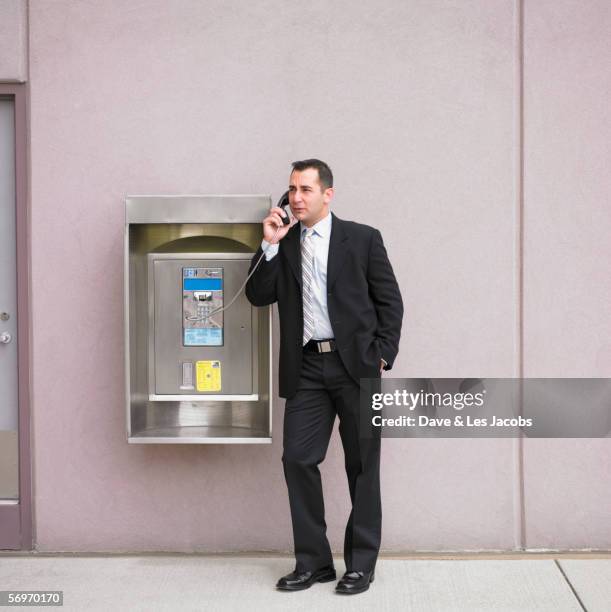 businessman talking on payphone - public phone stock pictures, royalty-free photos & images