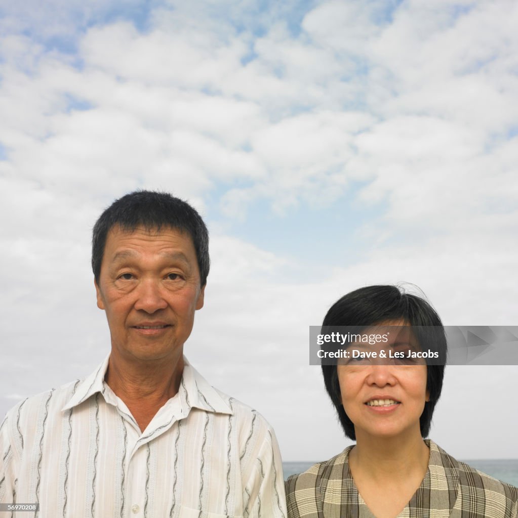 Portrait of couple standing at beach