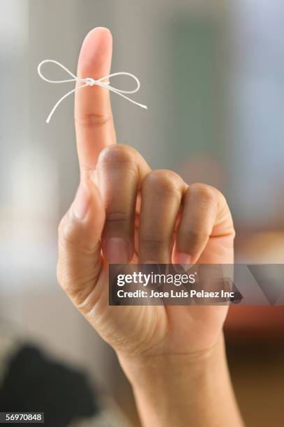 close up of finger tied in bow - string finger stock pictures, royalty-free photos & images