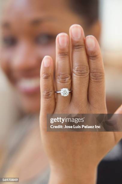 close up of hand with engagement ring - engagement ring foto e immagini stock