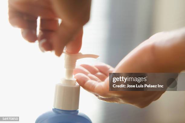 close up of hands applying lotion - bar of soap in hand stock pictures, royalty-free photos & images