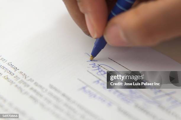 close up of hand signing document - medical document stock pictures, royalty-free photos & images