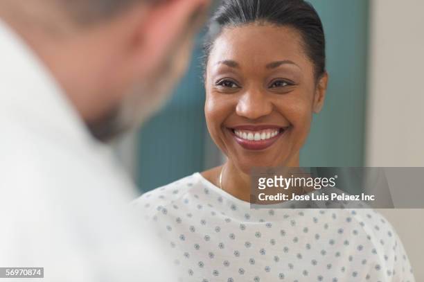 woman patient smiling at doctor - cuban doctors foto e immagini stock