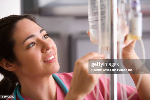 female nurse checking insulin - iv bag stock pictures, royalty-free photos & images