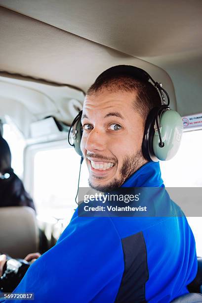 man with noise-cancelling headphones in a plane - peruvian airlines stock pictures, royalty-free photos & images