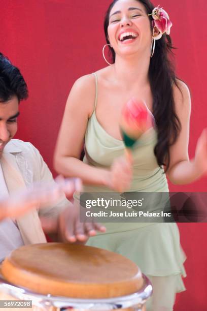 woman dancing while man plays conga - rhythmusinstrument stock-fotos und bilder