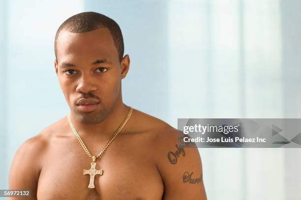 portrait of man wearing cross - collar up stockfoto's en -beelden