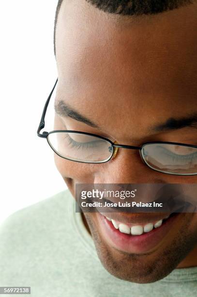 close up of man wearing glasses looking down - face down stock-fotos und bilder