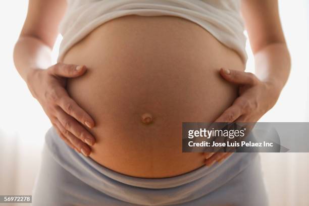 close up of pregnant woman's belly - stomach stock pictures, royalty-free photos & images