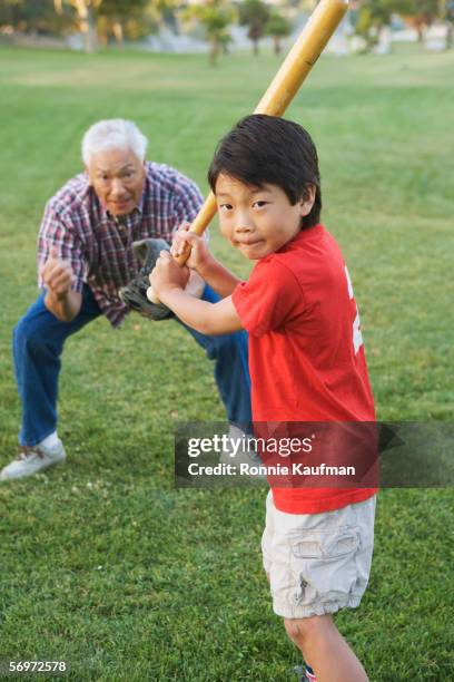 portrait of boy playing baseball with grandfather - asian games day 9 stock-fotos und bilder