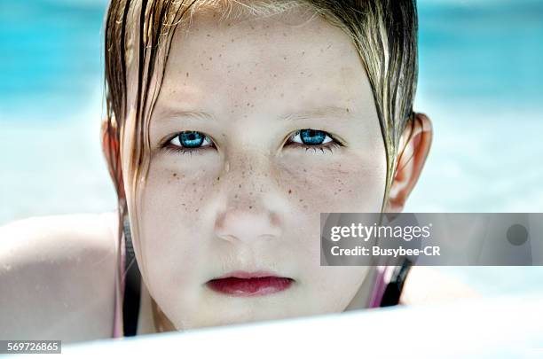 wet-haired, freckled faced girl in swimming pool - freckle faced stockfoto's en -beelden