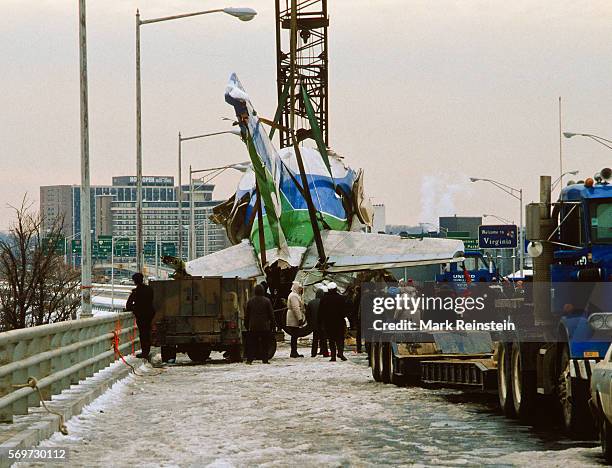 View along a bridge as a section of Air Florida Flight 90 is lifted, via crane, out of the Potomac River, Washington DC, January 20, 1982. On January...