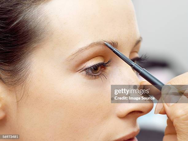 model having eyebrow pencil applied - eyebrow pencil fotografías e imágenes de stock