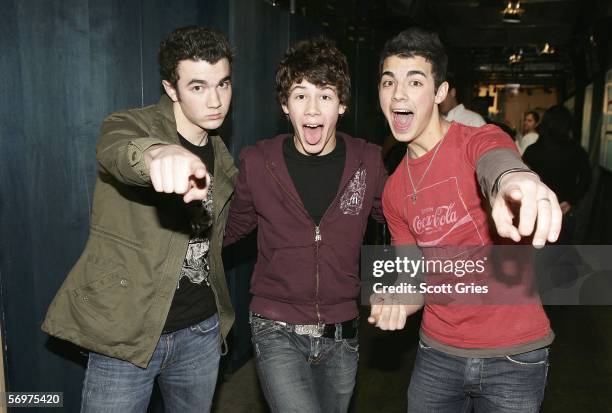 Kevin, Nicholas, and Joe Jonas of The Jonas Brothers pose for a photo backstage during MTV's Total Request Live at the MTV Times Square Studios March...