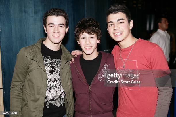 Kevin, Nicholas, and Joe Jonas of The Jonas Brothers pose for a photo backstage during MTV's Total Request Live at the MTV Times Square Studios March...