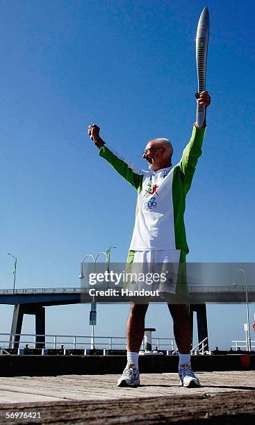 Robert Gardiner holds the Melbourne 2006 Queen's Baton on San Remo jetty during its journey from Traralgon to Cowes as part of the Melbourne 2006...