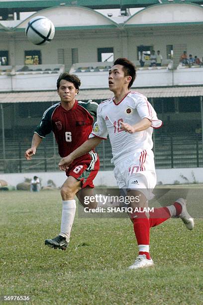 Hong Kong player Chan Yiu Lun vies for the ball with Bangladesh's Al Mamun during their AFC Asian Cup qualifying round match at the Bangabandhu...