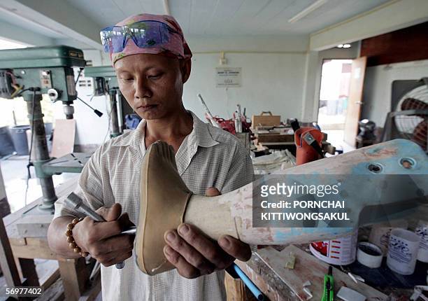 Myanmese worker makes an artificial leg for Myanmar refugees at Mae Tao Clinic in Mae Sot near Thai-Myanmar border, 31 January 2006. About 300 people...