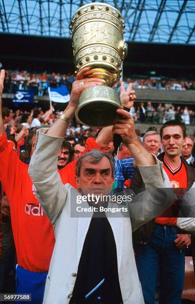 Head coach Ernst Happel of Hamburg celebrates with the trophy after winning the DFB German Cup final match between Hamburger SV and Stuttgarter...