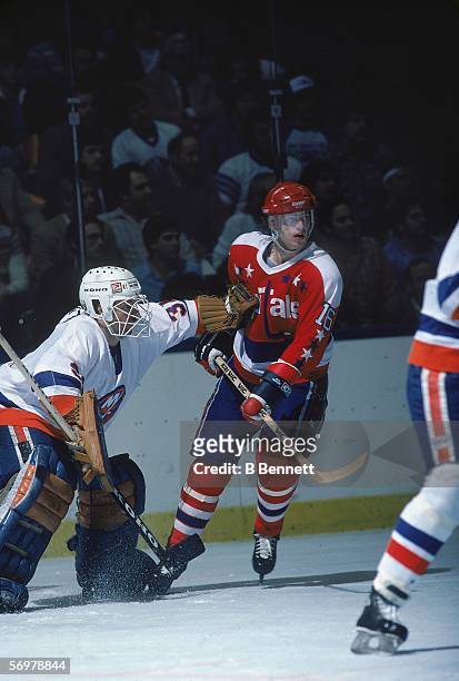Swedish hockey player Bengt Gustafsson of the Washington Capitals skates near New York Islanders goalie Billy Smith during a game at Nassau Coliseum,...