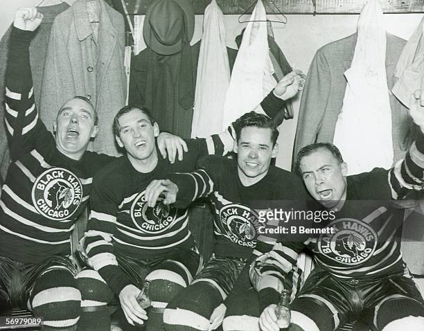 Chicago Blackhawks hockey players Jack Shill, Carl Voss, Carl 'Cully' Dahlstrom, and Harold 'Mush' March celebrate their Stanley Cup series winning...