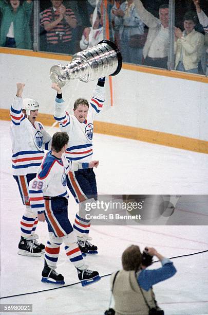 Mark Messier, Marty McSorley and Wayne Gretzky of the Edmonton Oilers celebrate their Stanley Cup victory over the Philadelphia Flyers after Game 7...