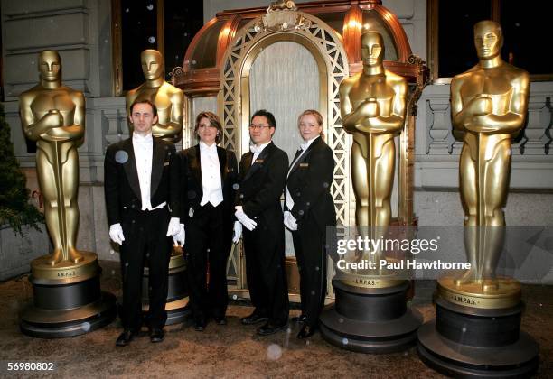 St Regis Hotel Butlers Chris Jastrzebski, Tamara Nisonova, Wonhee and Vildana Hadzialjevic pose with four, eight foot Oscar statues that were...