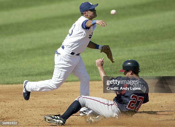 Oscar Robles of the Los Angeles Dodgers throws the ball to first base to complete a double play during the Major League Baseball spring training game...