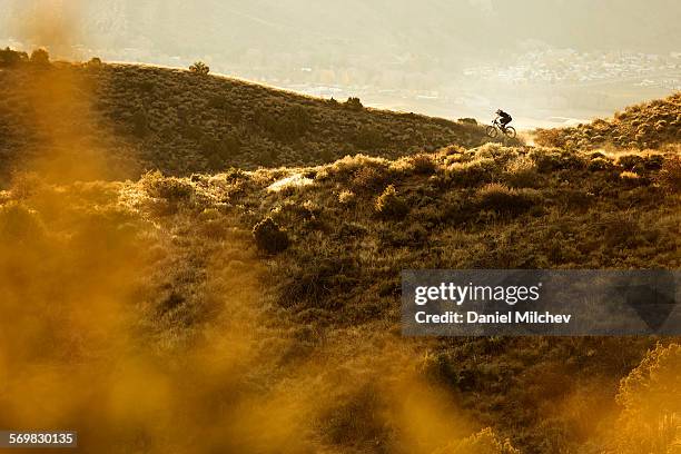 female bike rider juming with her mountain bike. - avon colorado stock pictures, royalty-free photos & images