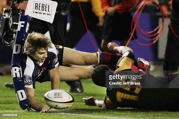 Drew Mitchell of the Queensland Reds crashes over the line to score a try during the round four Super 14 match between the Chiefs and the Queensland...