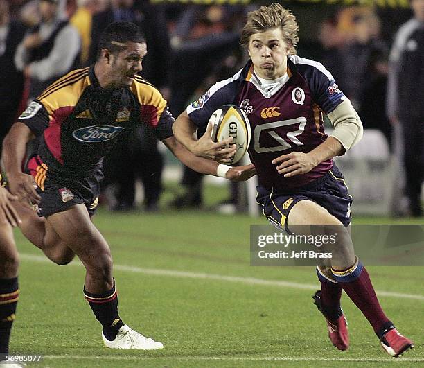 Drew Mitchell of the Queensland Reds looks for a way around the defence of the Chiefs during the round four Super 14 match between the Chiefs and the...