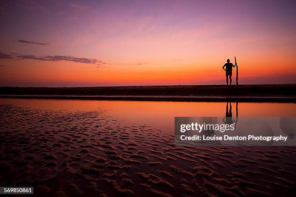 tribal pose at the beach - northern territory stock pictures, royalty-free photos & images