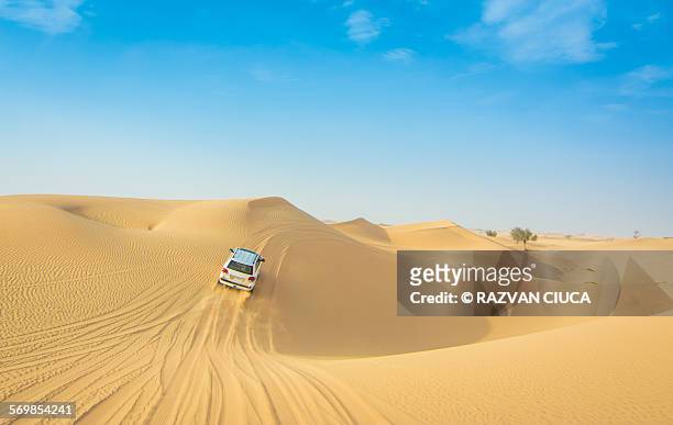 car drifting on desert dunes - daily life in abu dhabi stock pictures, royalty-free photos & images