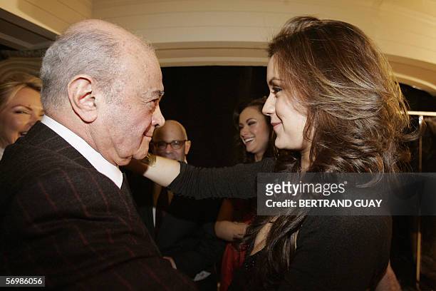 Half Egyptian and half Finnish designer Jasmine di Milo is congratulated by her father Egyptian tycoon Mohamed Al Fayed during the presentation of...