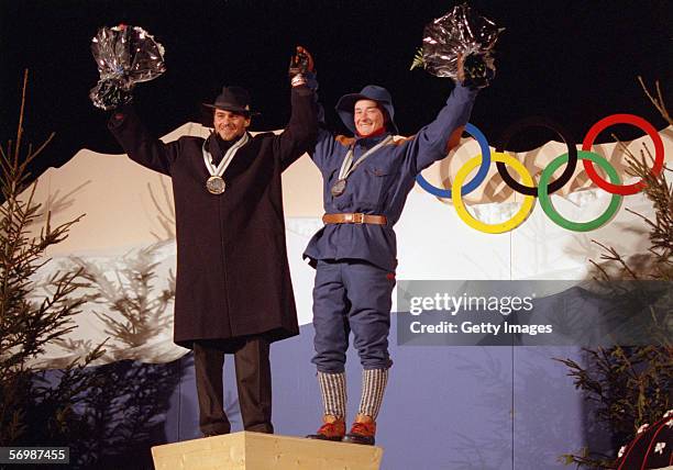 Gold medalist Alberto Tomba of Italy and Kjetil Andre Aamodt of Norway who won the bronze medal stand on the podium after the mens giant slalom, day...