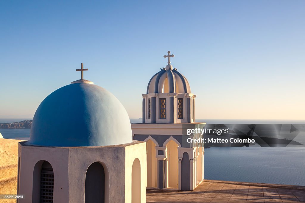 Sunset over blue domed churches in Santorini