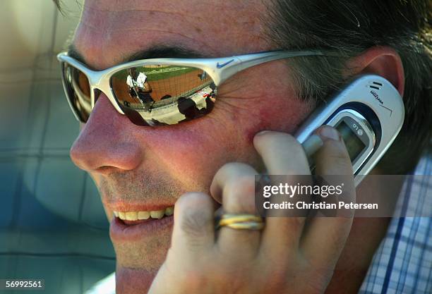 General manager Billy Beane of the Oakland Athletics talks on the phone during the MLB Spring Training game against the Milwaukee Brewers at Phoenix...