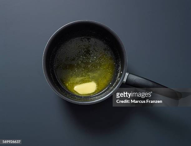 melting butter in a pan - melting pot foto e immagini stock
