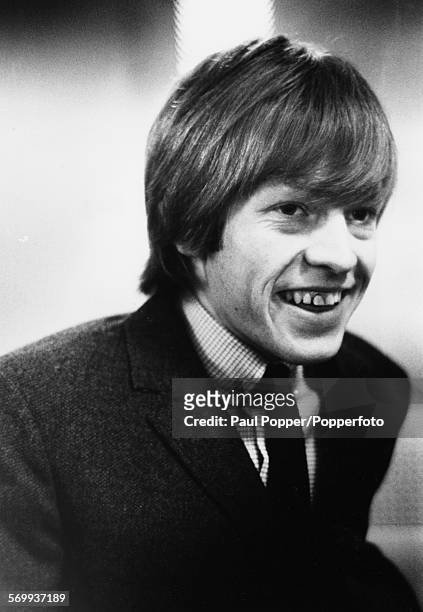English musician and guitarist with the Rolling Stones, Brian Jones pictured wearing a jacket and tie in 1963.