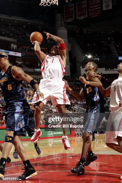 David Wesley of the Houston Rockets shoots between Kenyon Martin and ...