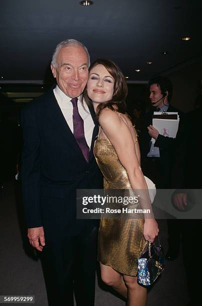 American businessman, Leonard Lauder and English actress, Elizabeth Hurley attending an event at Christie's, USA, circa 1999.