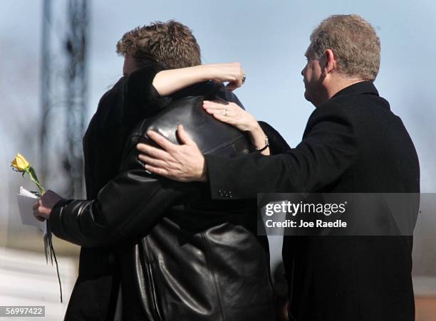 Mourners hug as they exit the Gormley Funeral Home after attending the funeral service for John Jay graduate student Imette St. Guillen March 4, 2006...