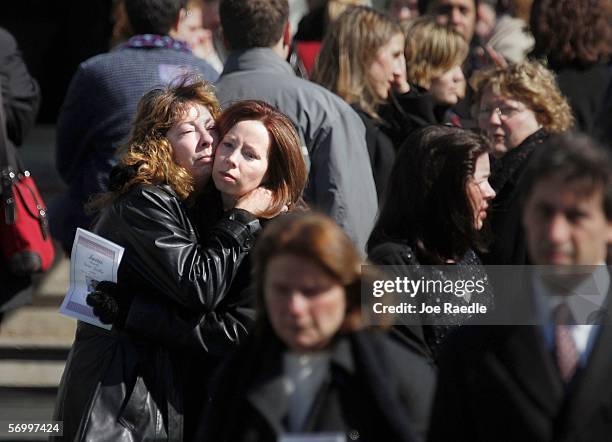 Mourners hug as they exit the Gormley Funeral Home after attending the funeral service for John Jay graduate student Imette St. Guillen March 4, 2006...