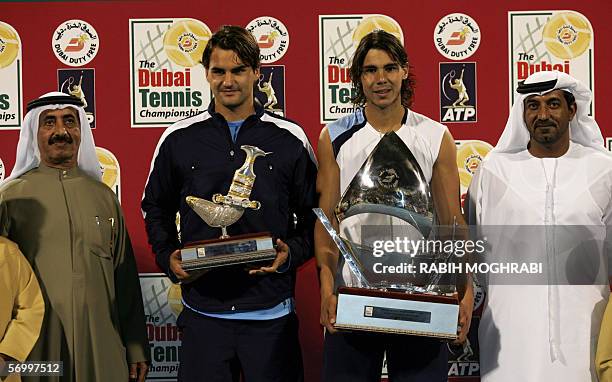 Dubai, UNITED ARAB EMIRATES: Rafael Nadal of Spain , winner of ATP Dubai Open, and Roger Federer of Switzerland, in second place, display their...