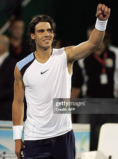 Dubai, UNITED ARAB EMIRATES: Rafael Nadal of Spain jubilates on the ground after winning the final match against Roger Federer of Switzerland during...