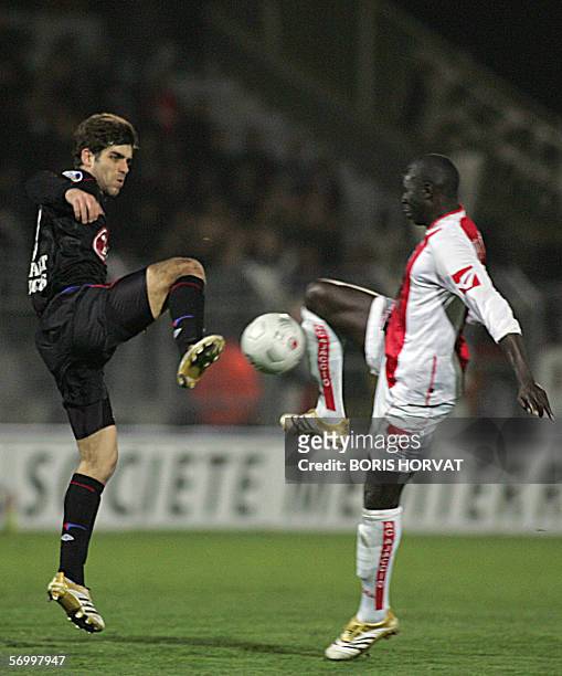 Lyon's midfielder Juninho from Brazil vies with AC Ajaccio forward Moussa N'Diaye from Senegal during the L1 football match Ajaccio-Lyon,04 March...